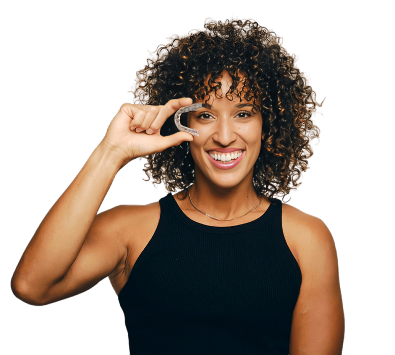 Smiling woman making phone gesture against white background for dental practice contact.